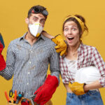 Maintenance workers wearing casual clothes holding builduing equipment having surprised look not believing their eyes that they finished their work so quickly. Teamwork and suddenness concept
