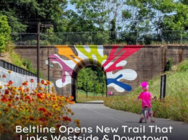 Photo by Metro Atlanta Chamber on June 24, 2025. May be an image of 1 person, bridge and text that says 'JNE Beltline Opens New Trail That Links Westside & Downtown URBANIZE'.